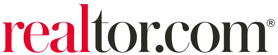 The wordmark logo for "realtor.com" set against a white background. The letters "real" are written in a bright red serif font, followed immediately by "tor.com" in a dark grey or black serif font with a registered trademark symbol superscripted at the top right.